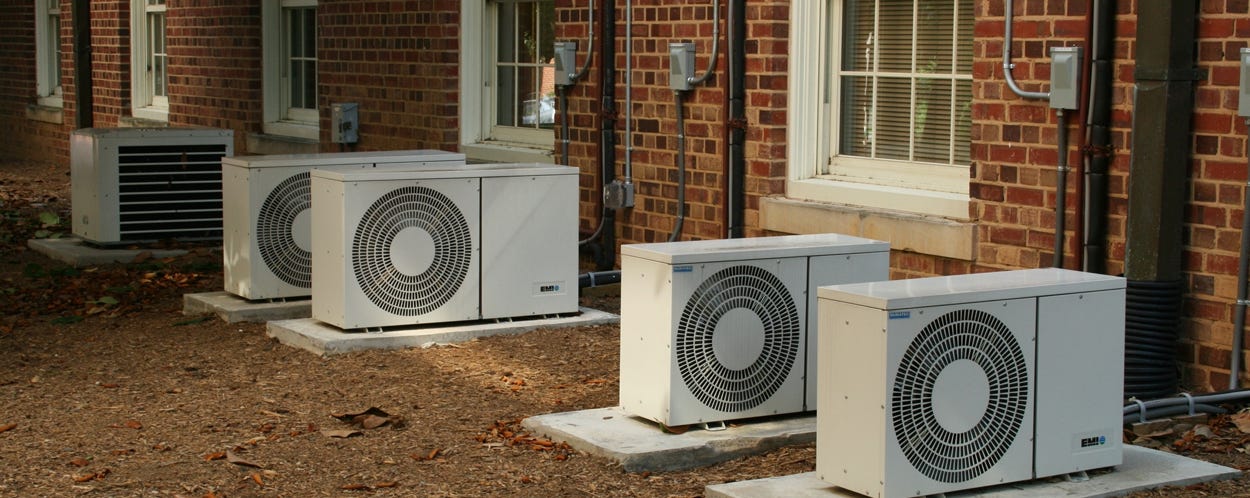 Old house exterior with air conditioning units on walls